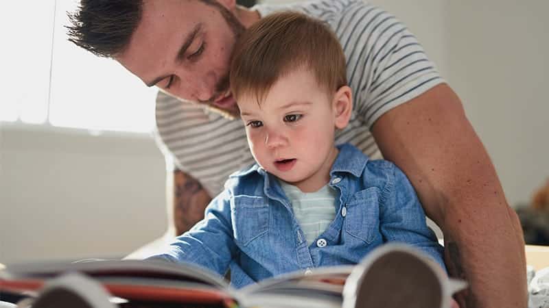 Dad reading to son