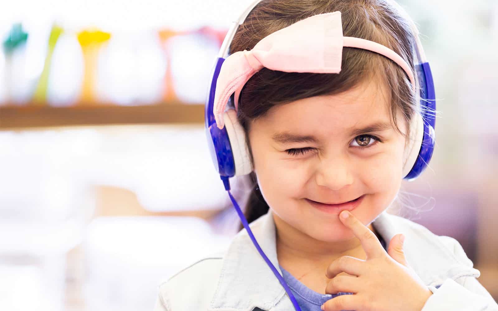 Child wearing headset winking at the camera