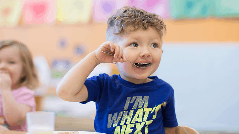Child eating in blue shirt